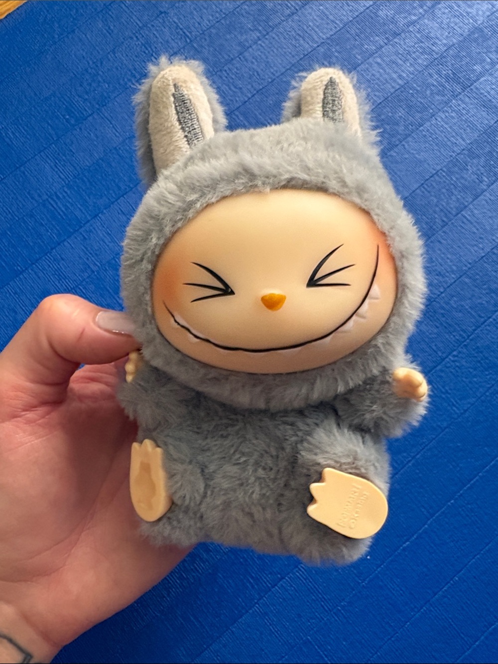 The Monsters Labubu HeHe Have A Seat Keychain in Gray